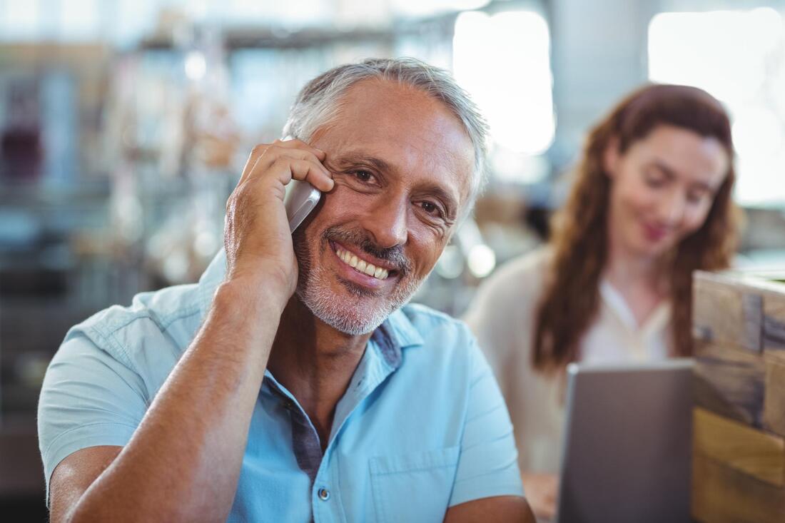 man smile taking phone call