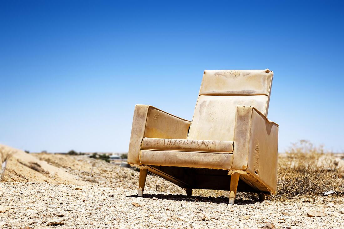 old leather chair on the road ready for removal